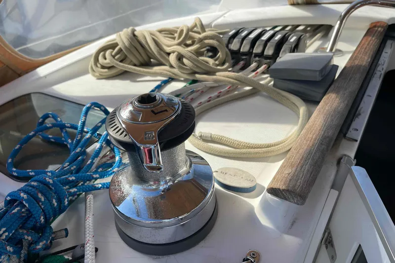 Tiramisu Yacht Photos Pics Deck of 2004 Beneteau Oceanis 473 with winch, ropes, and control panel.