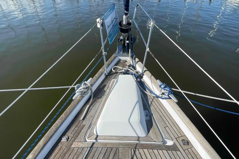 Tiramisu Yacht Photos Pics Bow of 2004 Beneteau Oceanis 473 sailboat with teak deck and mooring ropes.