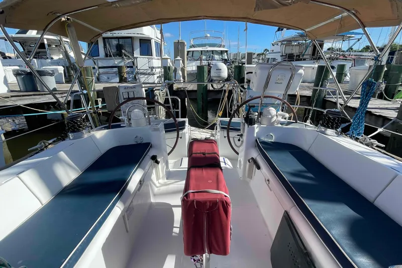 Tiramisu Yacht Photos Pics Cockpit of 2004 Beneteau Oceanis 473 sailboat docked at marina, featuring dual steering wheels.
