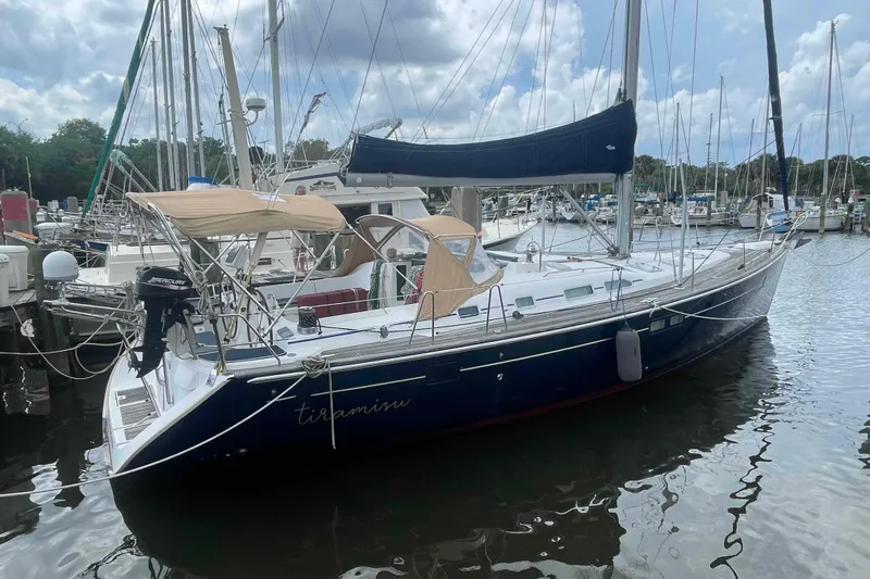 Tiramisu Yacht Photos Pics 2004 Beneteau Oceanis 473 sailboat docked in marina, featuring blue hull and beige canopy.