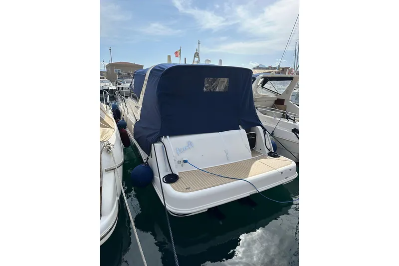 Piccopi Yacht Photos Pics 2007 Mano Marine 32.50 Sport boat docked with blue cover in marina.