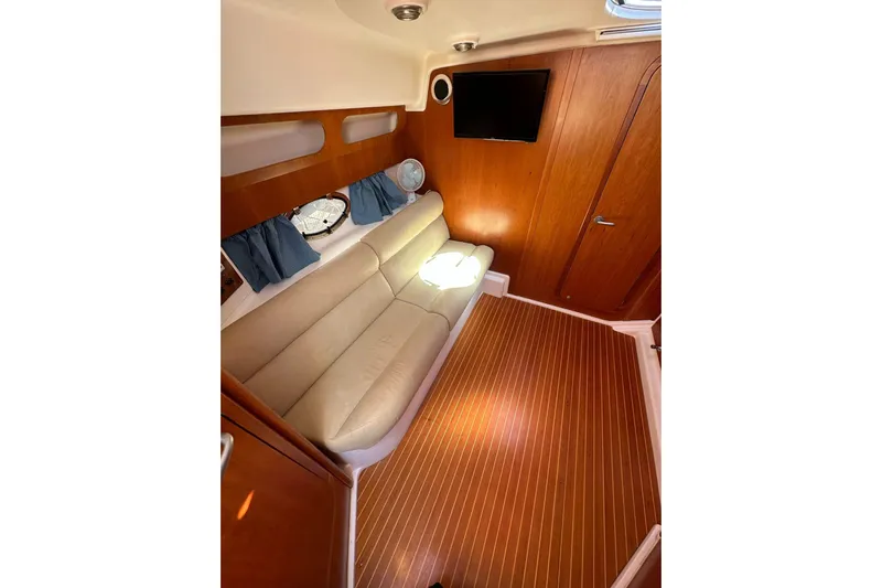 Piccopi Yacht Photos Pics Interior of 2007 Mano Marine 32.50 Sport with beige sofa and wooden flooring.