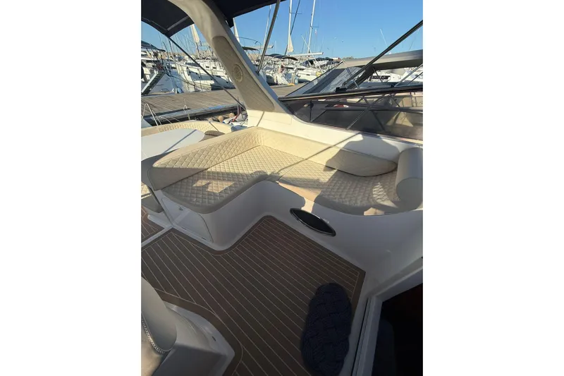 Piccopi Yacht Photos Pics 2007 Mano Marine 32.50 Sport boat interior with cushioned seating and marina view.