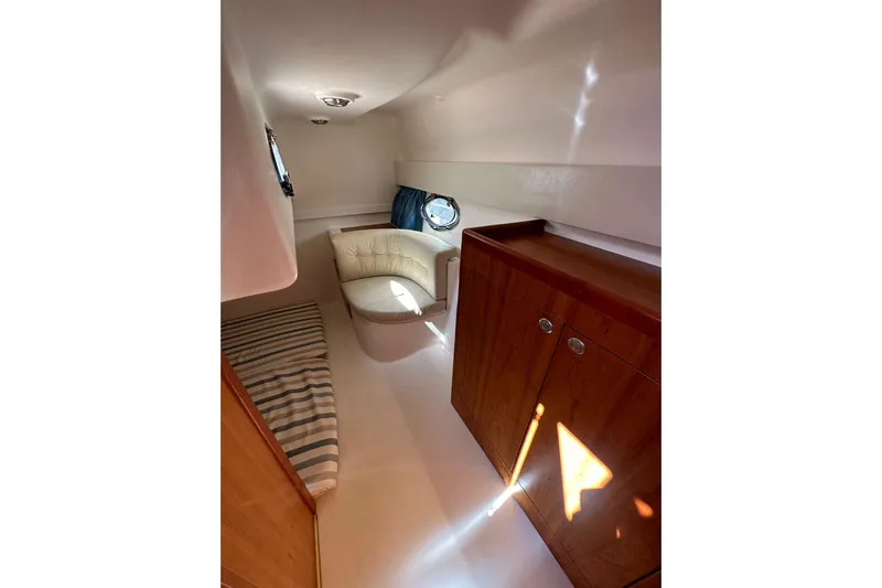 Piccopi Yacht Photos Pics Interior of 2007 Mano Marine 32.50 Sport yacht with seating and wooden cabinetry.