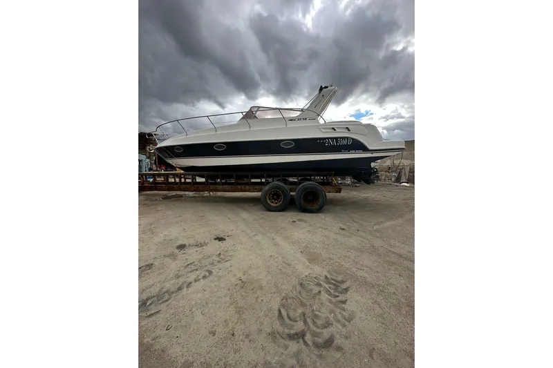 Piccopi Yacht Photos Pics 2007 Mano Marine 32.50 Sport boat on trailer under cloudy sky.