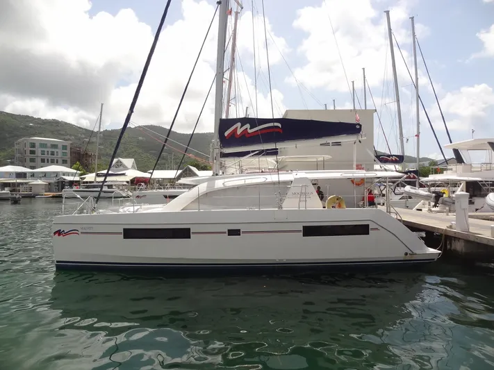 Maupiti Yacht Photos Pics 2019 Leopard 40 catamaran docked at a marina with scenic background.