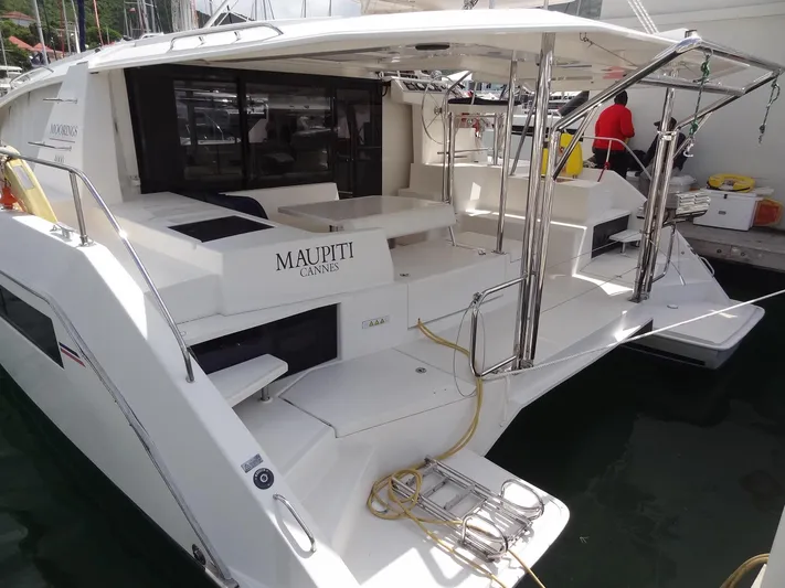 Maupiti Yacht Photos Pics 2019 Leopard 40 catamaran docked, featuring spacious deck and seating area.
