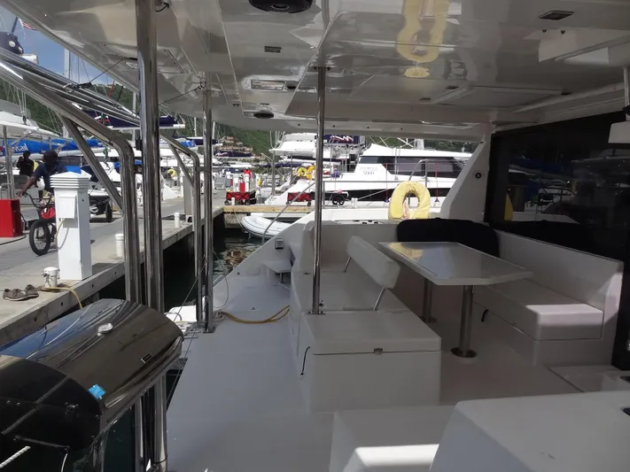 Maupiti Yacht Photos Pics Leopard 40 catamaran 2019 model docked, featuring spacious outdoor seating and dining area.