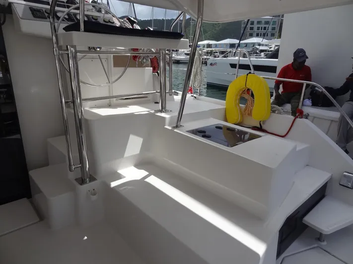 Maupiti Yacht Photos Pics 2019 Leopard 40 catamaran cockpit with seating, helm station, and life preserver.