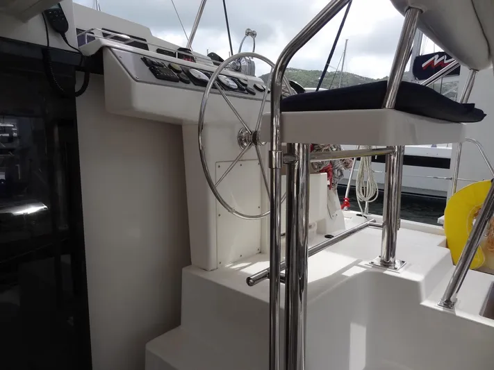 Maupiti Yacht Photos Pics Helm station of a 2019 Leopard 40 catamaran with steering wheel and controls.