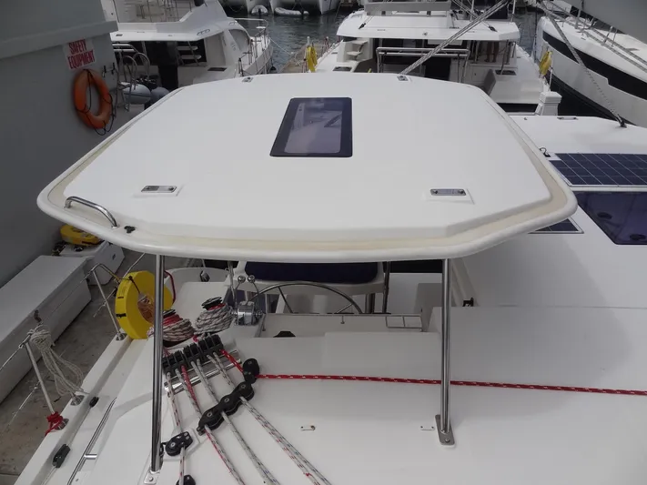 Maupiti Yacht Photos Pics 2019 Leopard 40 catamaran docked, showing the helm station and rigging.