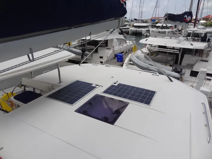 Maupiti Yacht Photos Pics 2019 Leopard 40 catamaran with solar panels docked at a marina.