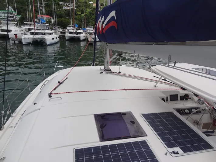 Maupiti Yacht Photos Pics 2019 Leopard 40 catamaran with solar panels docked in a marina.