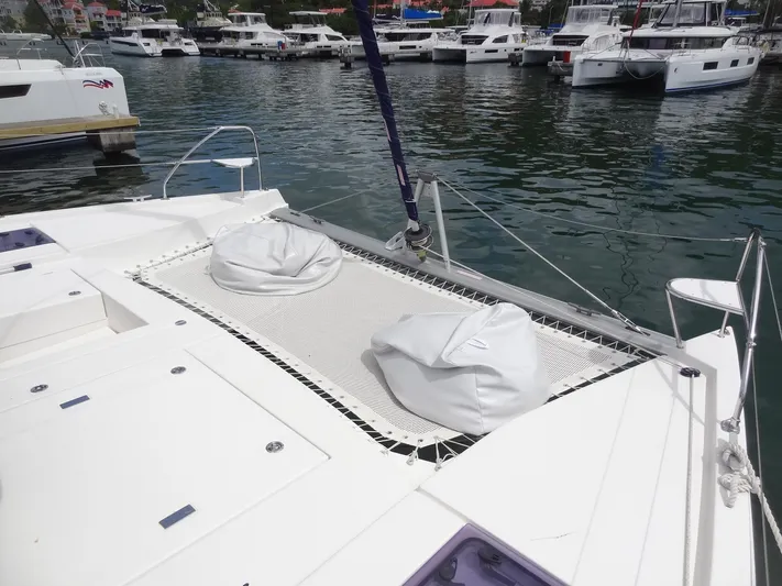 Maupiti Yacht Photos Pics Leopard 40 catamaran 2019 with bean bags on netting at marina.