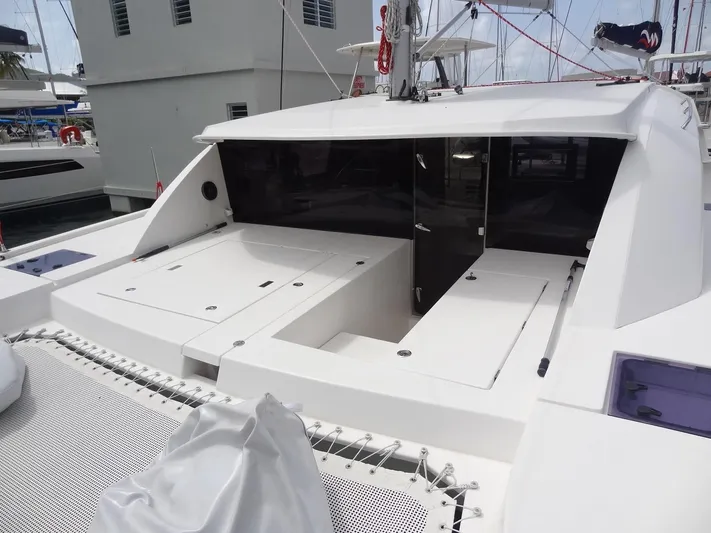 Maupiti Yacht Photos Pics 2019 Leopard 40 catamaran's deck and cockpit area in a marina.