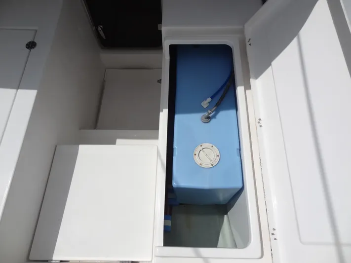 Maupiti Yacht Photos Pics Open storage compartment with blue water tank on a 2019 Leopard 40 catamaran.
