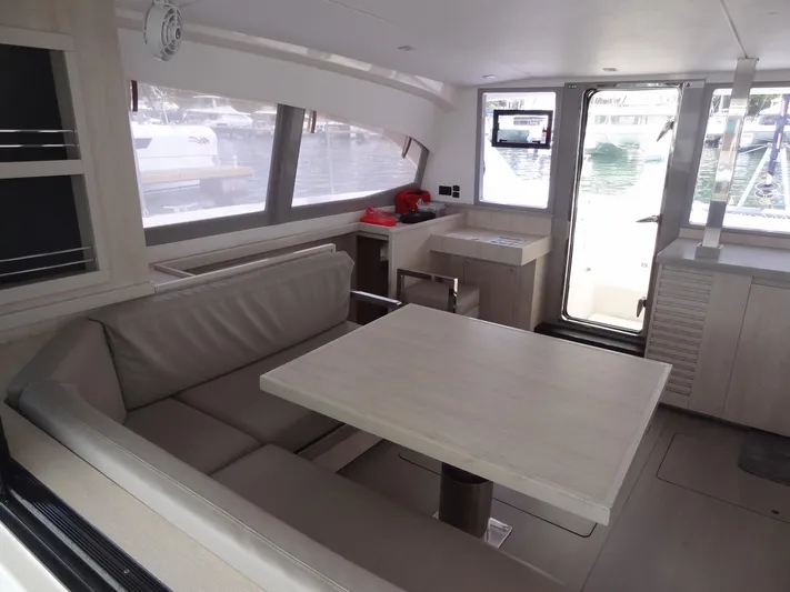 Maupiti Yacht Photos Pics Modern interior of 2019 Leopard 40 catamaran with dining area and large windows.