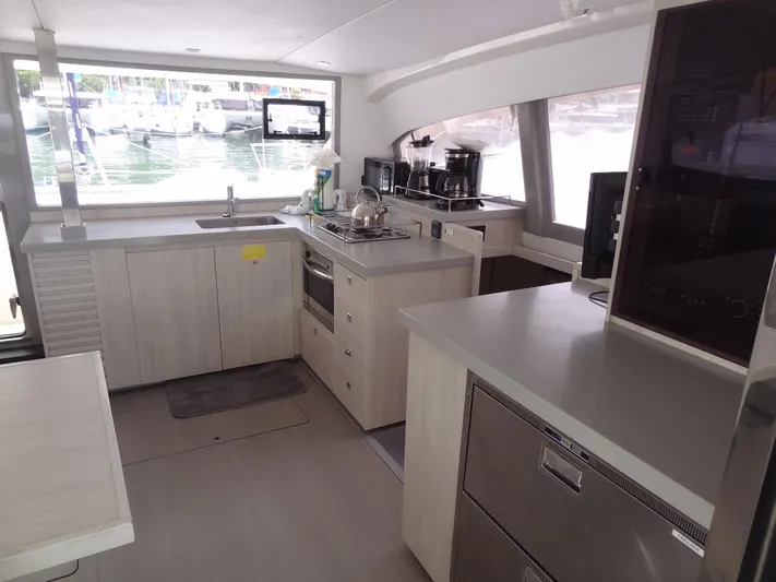 Maupiti Yacht Photos Pics Modern kitchen interior of 2019 Leopard 40 catamaran with appliances and marina view.
