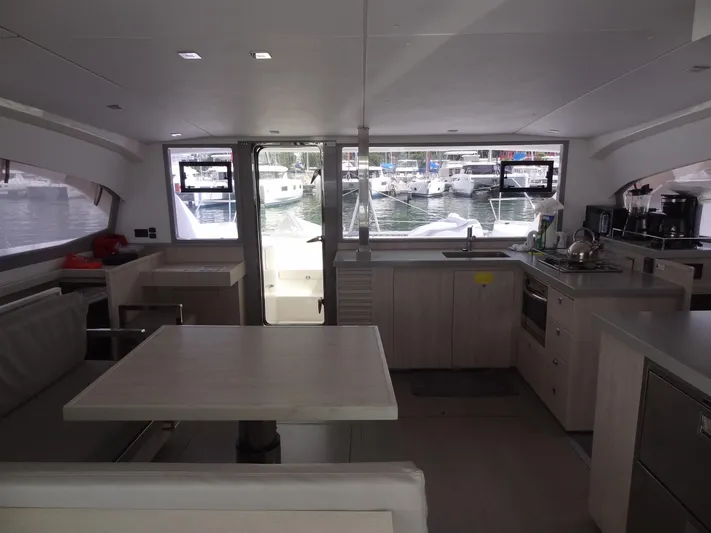 Maupiti Yacht Photos Pics Interior of 2019 Leopard 40 catamaran with modern kitchen and dining area.