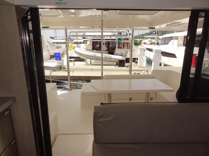 Maupiti Yacht Photos Pics Interior view of 2019 Leopard 40 catamaran with docked boats in the background.