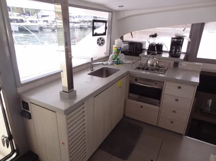 Maupiti Yacht Photos Pics Modern kitchen area on a 2019 Leopard 40 catamaran with appliances and marina view.