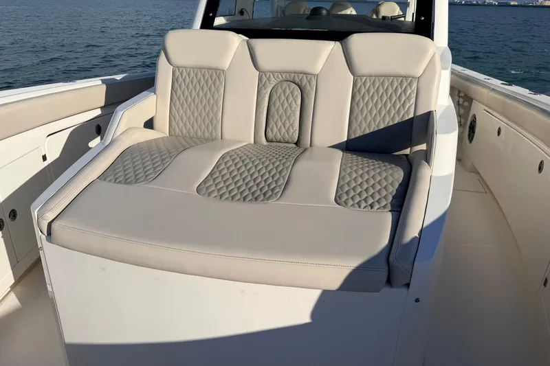 Vandy Yacht Photos Pics Luxurious seating on 2024 Solace 41 CS boat, featuring quilted upholstery and ocean backdrop.