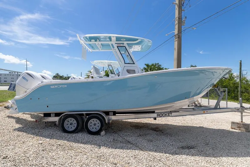  Yacht Photos Pics 2026 Sea Fox 268 Commander boat on trailer, light blue hull, parked outdoors.