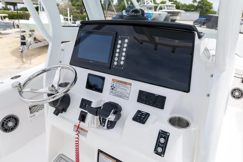  Yacht Photos Pics Helm of 2026 Sea Fox 268 Commander with steering wheel and navigation controls.