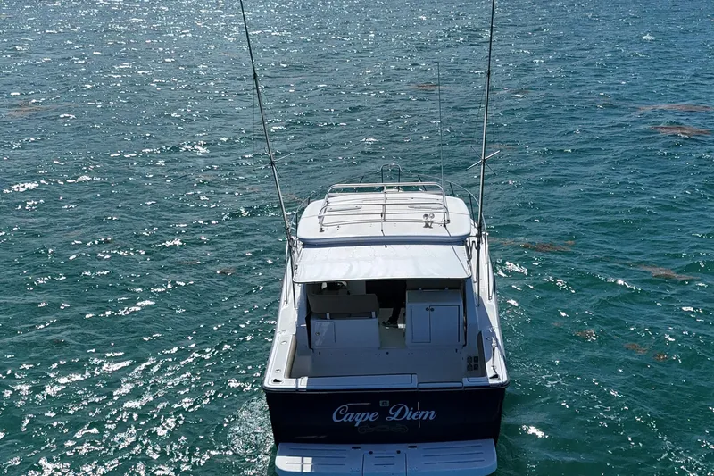  Yacht Photos Pics 2005 Tiara Yachts 3200 Open on sparkling blue water, rear view.