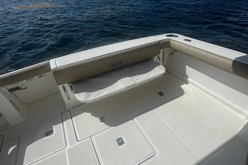  Yacht Photos Pics 2005 Tiara Yachts 3200 Open boat deck with cushioned seating by the water.