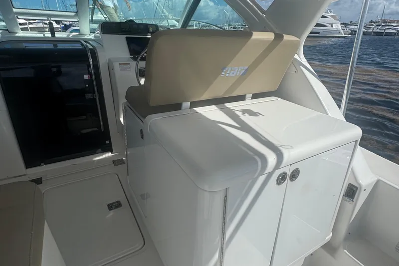  Yacht Photos Pics 2005 Tiara Yachts 3200 Open interior with helm and seating, docked by the water.