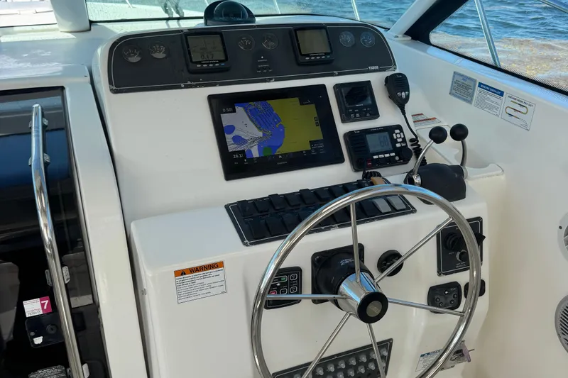  Yacht Photos Pics Helm of 2005 Tiara Yachts 3200 Open with navigation equipment and steering wheel.