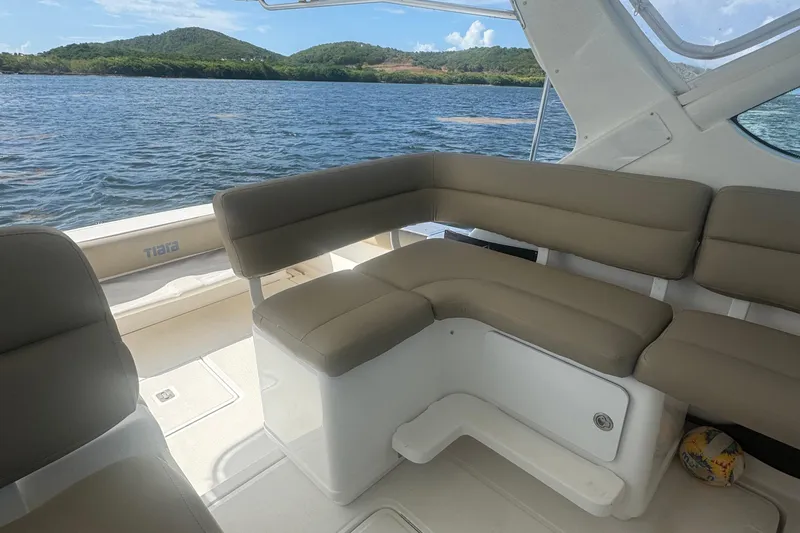  Yacht Photos Pics 2005 Tiara Yachts 3200 Open interior with beige seating, overlooking scenic water and hills.