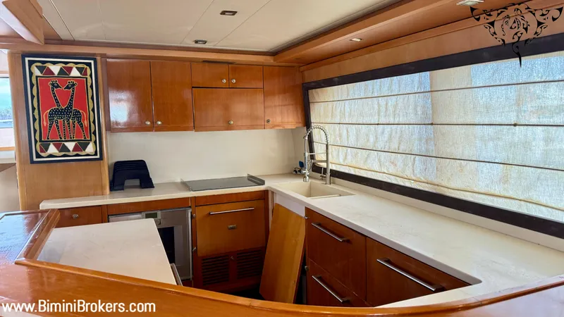  Yacht Photos Pics Luxurious kitchen interior of 2011 Bertram 800 yacht with modern wood cabinetry.