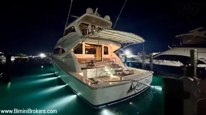  Yacht Photos Pics Luxurious 2011 Bertram 800 yacht illuminated at night in marina.