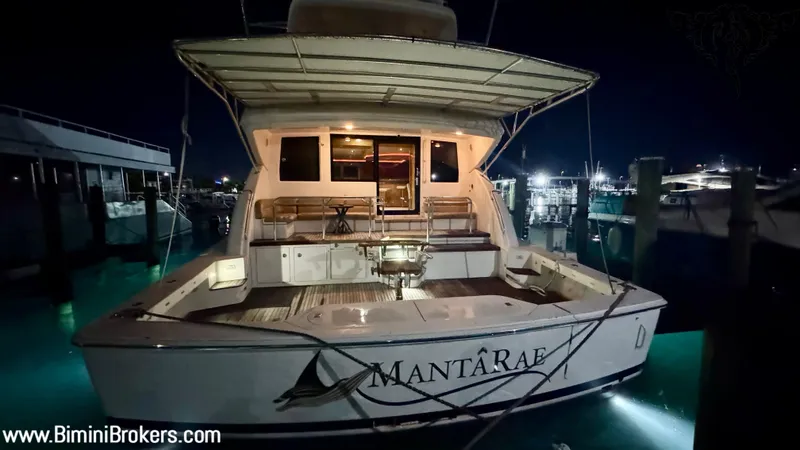  Yacht Photos Pics 2011 Bertram 800 yacht "Mantaray" docked at night, illuminated, with visible website URL.
