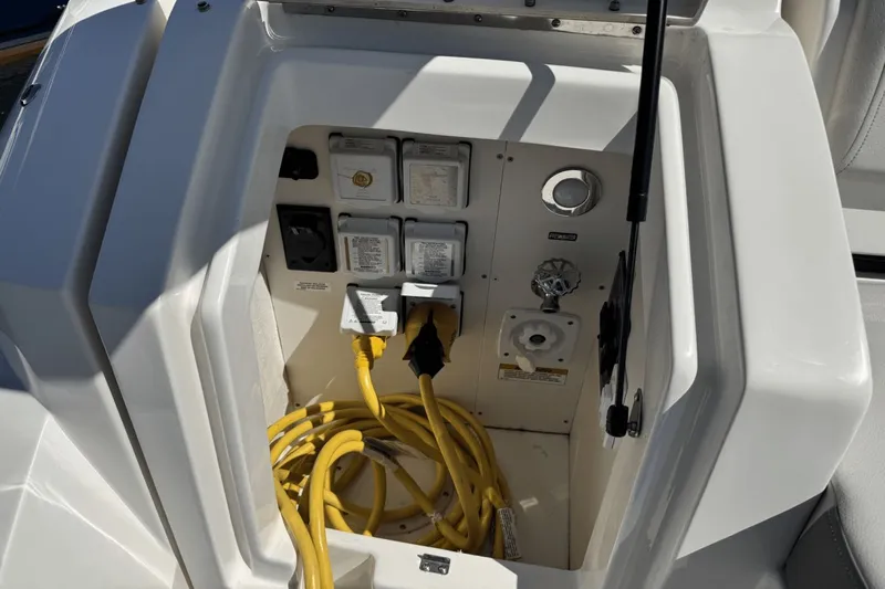  Yacht Photos Pics Electrical compartment of 2023 Sea Ray 320 Sundancer with yellow power cables and outlets.
