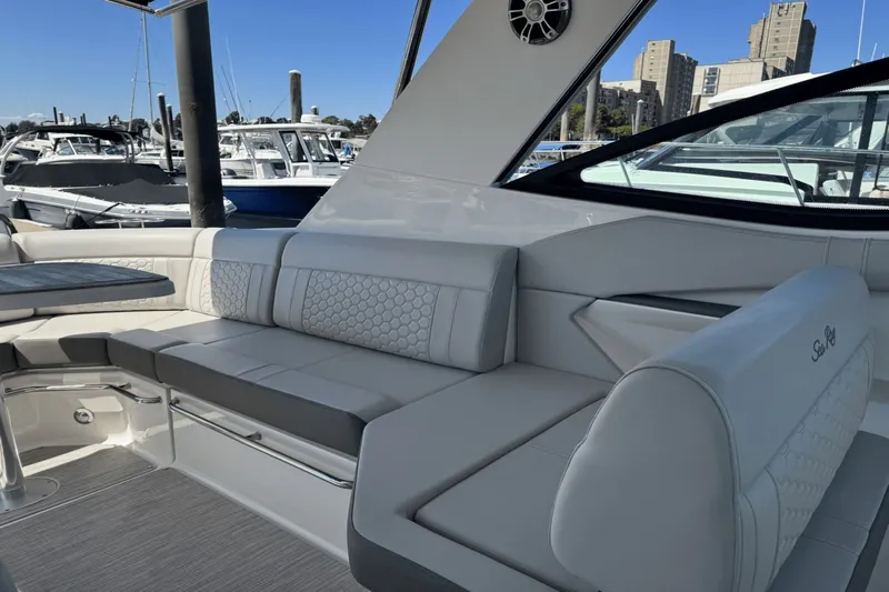  Yacht Photos Pics Luxurious seating on 2023 Sea Ray 320 Sundancer yacht, docked in a marina.