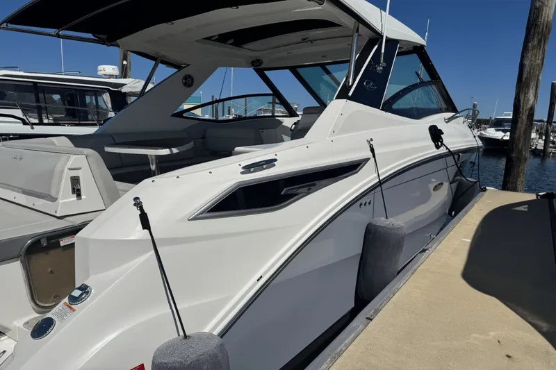  Yacht Photos Pics 2023 Sea Ray 320 Sundancer docked at marina under clear blue sky.