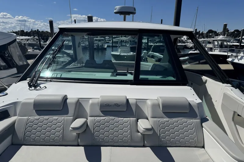  Yacht Photos Pics 2023 Sea Ray 320 Sundancer boat with sleek design and comfortable seating at a marina.