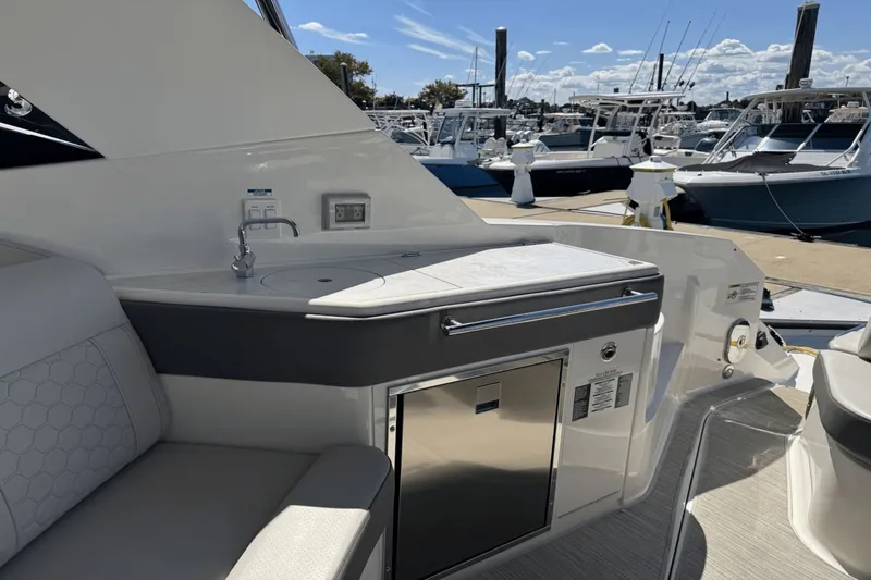  Yacht Photos Pics 2023 Sea Ray 320 Sundancer yacht interior with kitchenette and marina view.