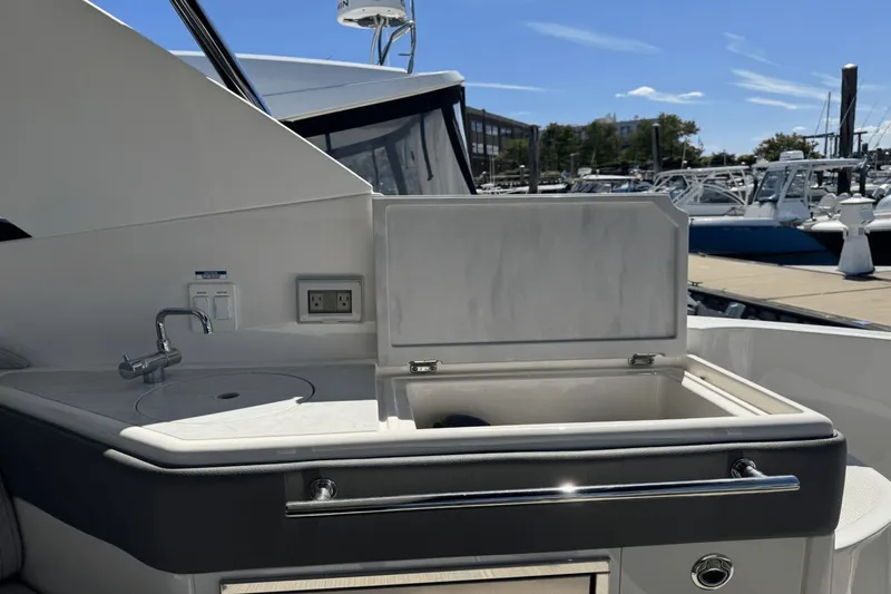  Yacht Photos Pics 2023 Sea Ray 320 Sundancer yacht kitchenette with sink and storage at marina.