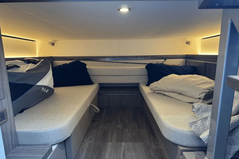  Yacht Photos Pics 2023 Sea Ray 320 Sundancer cabin interior with cozy seating and soft lighting.