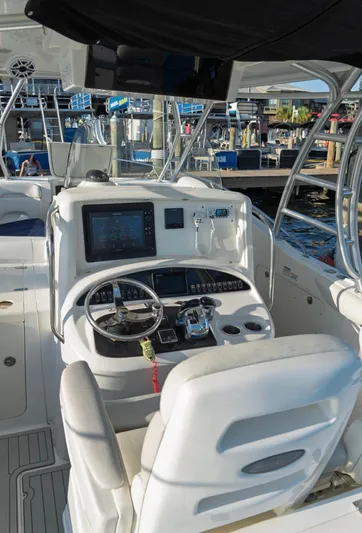  Yacht Photos Pics 2006 Boston Whaler 320 Outrage Cuddy Cabin helm with modern controls and navigation system.