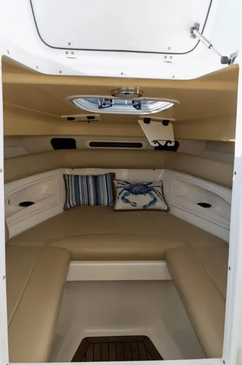  Yacht Photos Pics 2006 Boston Whaler 320 Outrage Cuddy Cabin interior with cushions and decorative pillows.