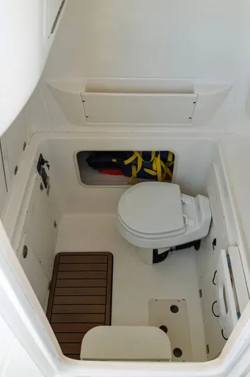  Yacht Photos Pics 2006 Boston Whaler 320 Outrage Cuddy Cabin interior with toilet and storage compartment.