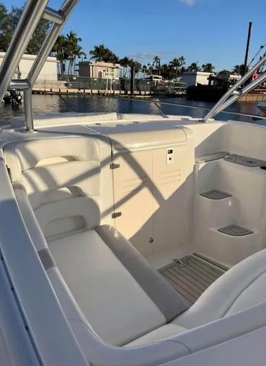  Yacht Photos Pics 2006 Boston Whaler 320 Outrage Cuddy Cabin interior with white seating and storage compartments.
