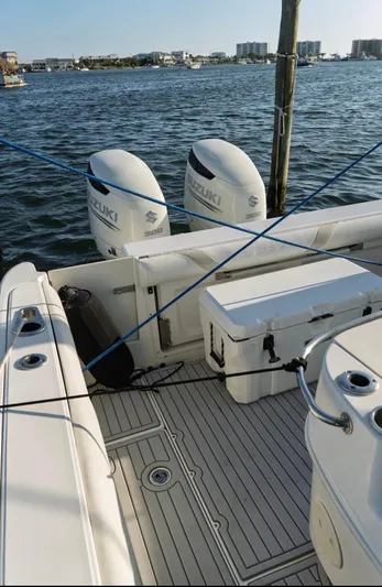 Yacht Photos Pics 2006 Boston Whaler 320 Outrage Cuddy Cabin with Suzuki engines docked by the water.