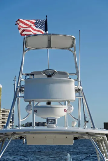  Yacht Photos Pics 2006 Boston Whaler 320 Outrage Cuddy Cabin with American flag, radar equipment, and clear blue sky.