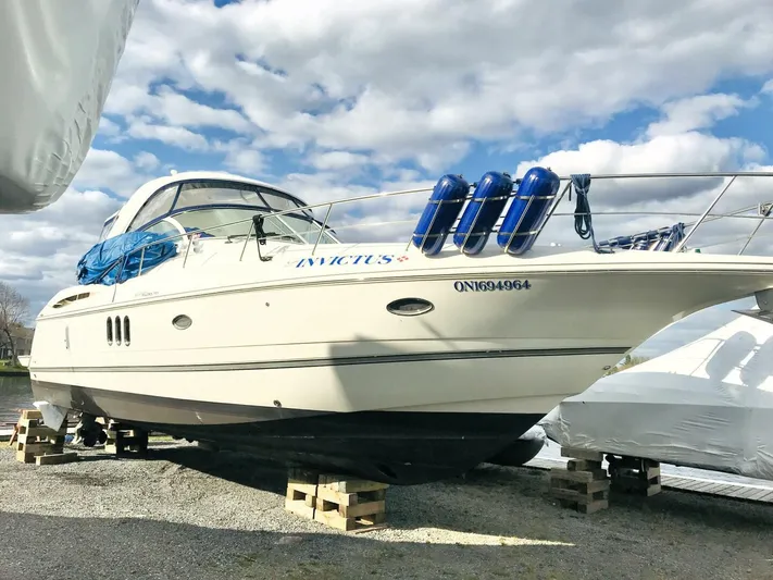  Yacht Photos Pics 2006 Cruisers Yachts 420 Express on dry dock, under a partly cloudy sky.